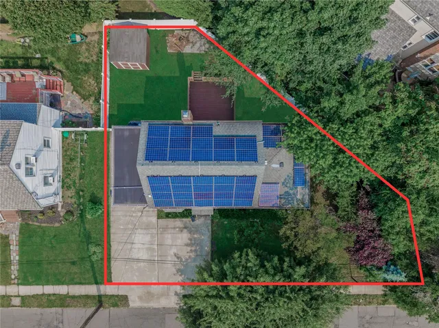 a aerial view of a house with a yard and balcony