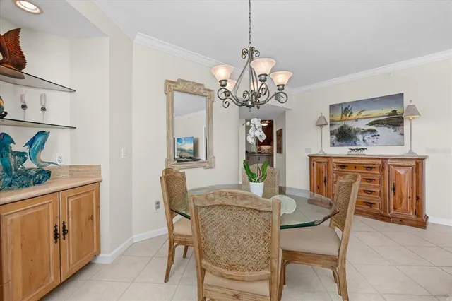 a view of a dining room with furniture and chandelier