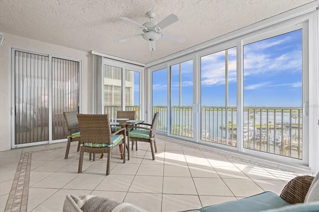 a dining room with furniture and large windows