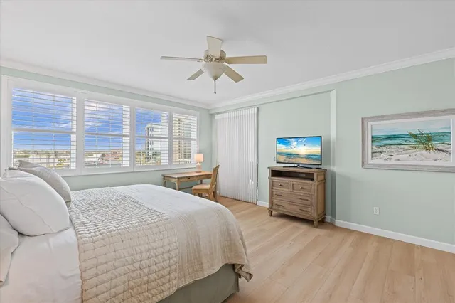 a living room with stainless steel appliances furniture and a large window