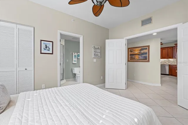 a bedroom with bed and wall painting