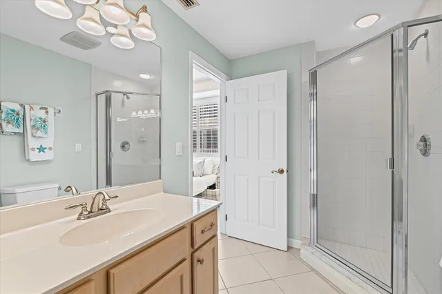 a bathroom with a double vanity sink mirror and shower
