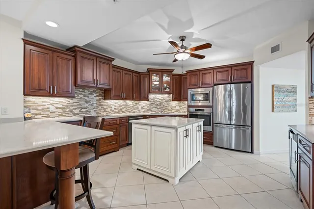 a kitchen with stainless steel appliances granite countertop a stove refrigerator sink and dishwasher