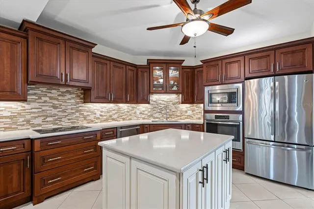 a kitchen with a sink stainless steel appliances and cabinets