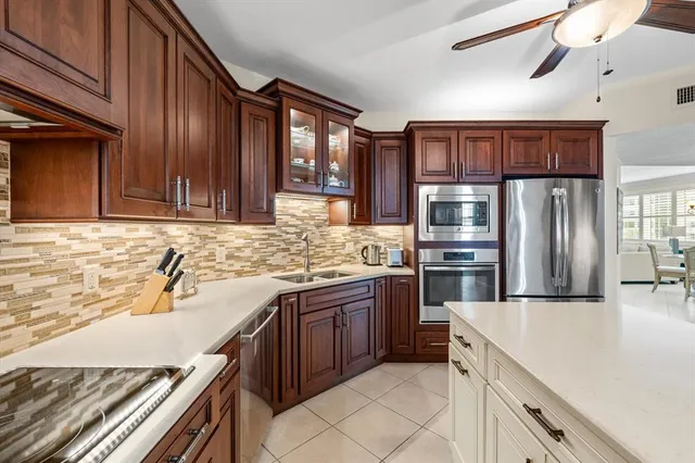 a kitchen with granite countertop stainless steel appliances and wooden cabinets