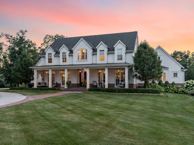 a front view of a house with a garden and yard