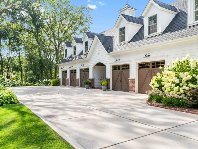a kitchen with stainless steel appliances kitchen island wooden cabinets and a window