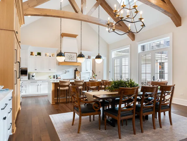 a dining room with furniture a chandelier and wooden floor