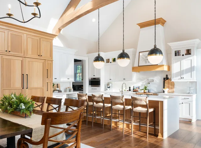 a view of a dining room with furniture a chandelier and wooden floor