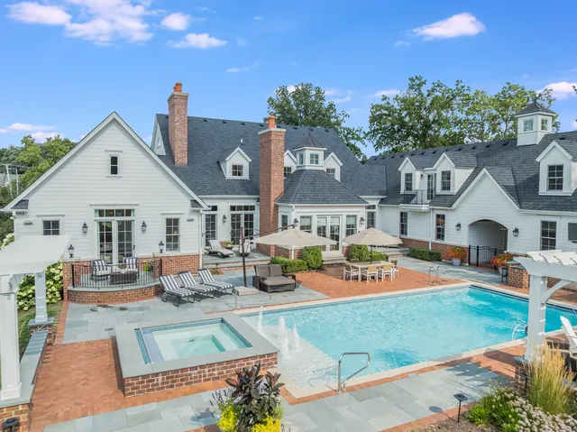 an aerial view of a house with swimming pool and patio
