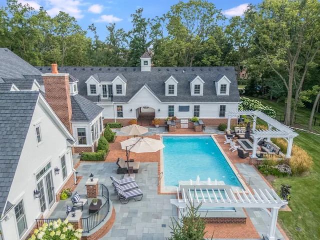 an aerial view of a house with a swimming pool outdoor seating and yard