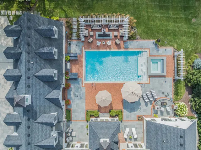 a view of a swimming pool with chairs in patio