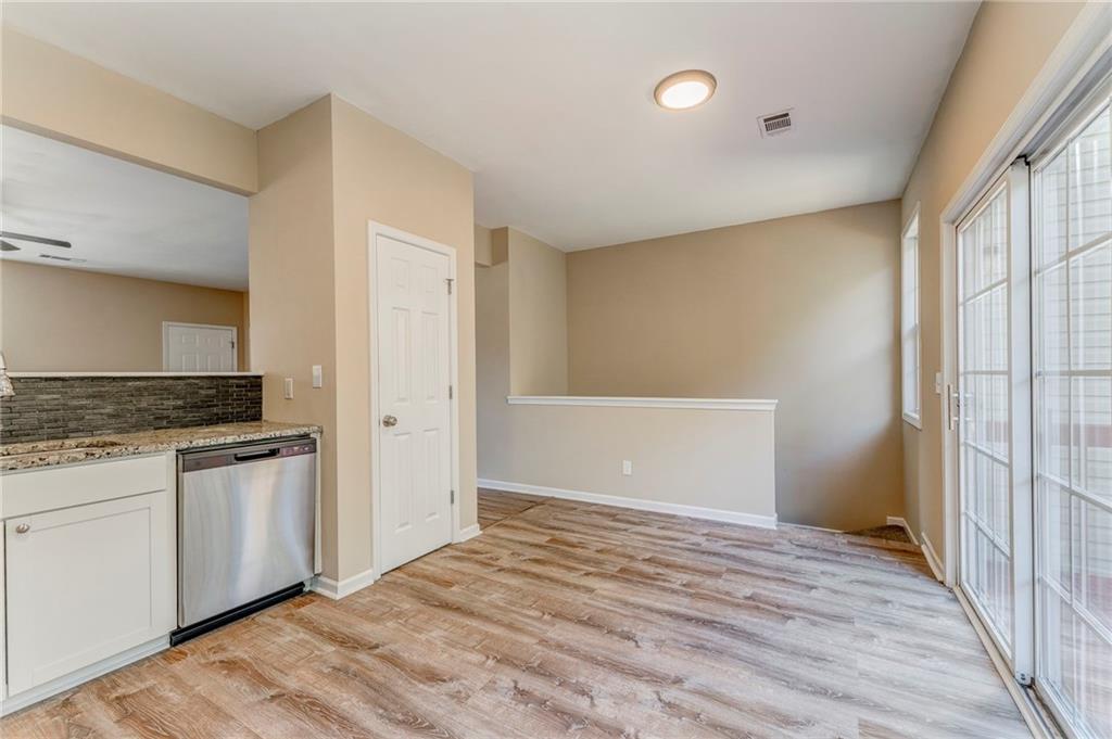 209 Enterprise Path Hiram, GA 30141 - Photo 12 of 31 a view of a kitchen with a sink and dishwasher a refrigerator with wooden floor