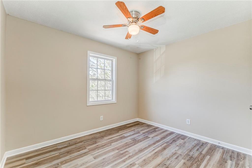 209 Enterprise Path Hiram, GA 30141 - Photo 17 of 31 an empty room with a window and a ceiling fan