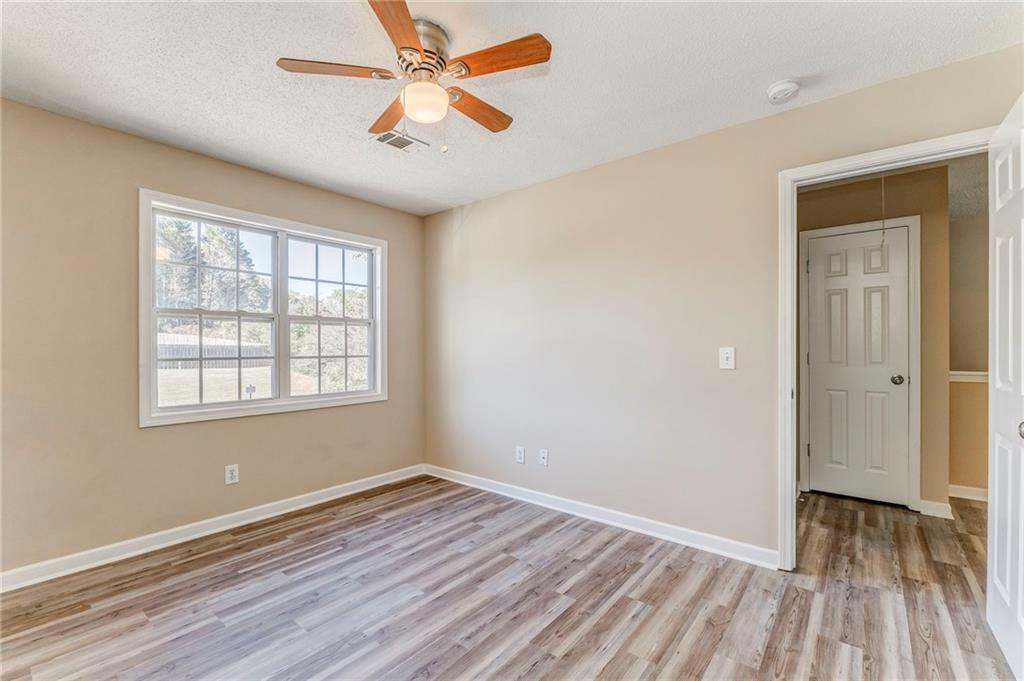 209 Enterprise Path Hiram, GA 30141 - Photo 18 of 31 wooden floor in an empty room with a window