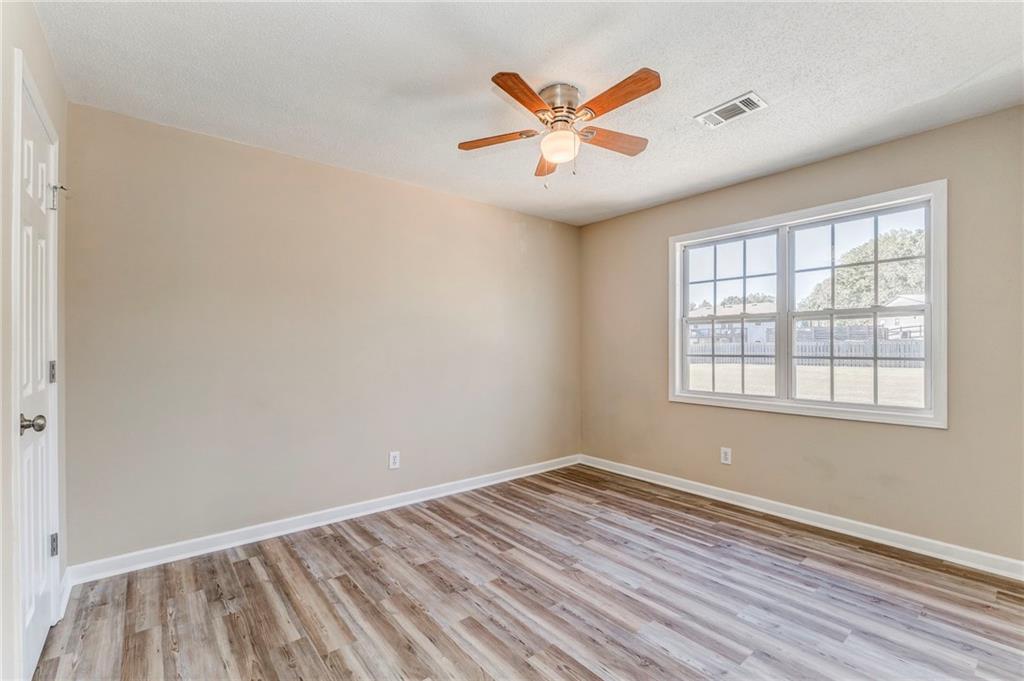 209 Enterprise Path Hiram, GA 30141 - Photo 23 of 31 an empty room with wooden floor and windows