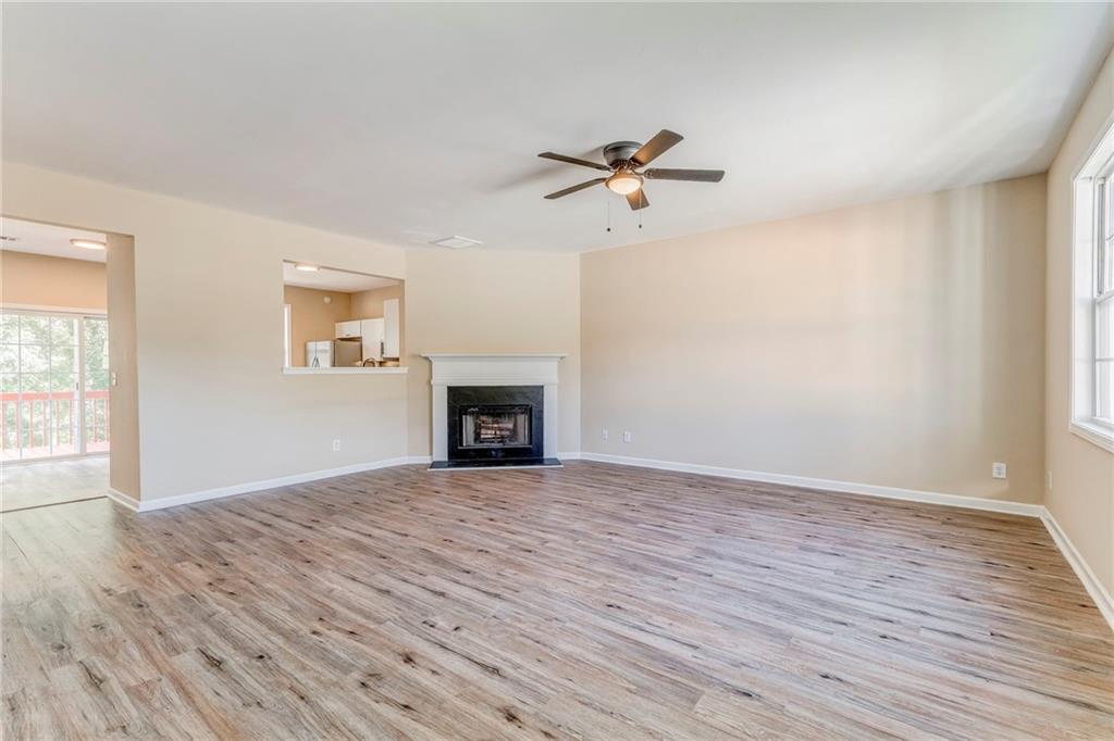 209 Enterprise Path Hiram, GA 30141 - Photo 3 of 31 a view of empty room with wooden floor and fireplace
