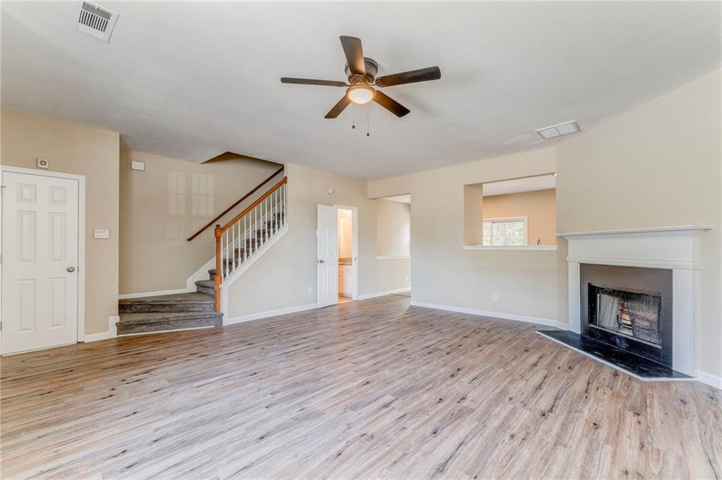 209 Enterprise Path Hiram, GA 30141 - Photo 4 of 31 a view of an empty room with wooden floor fireplace and a window