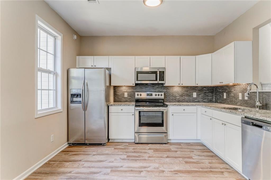 209 Enterprise Path Hiram, GA 30141 - Photo 10 of 31 a kitchen with a refrigerator stove and sink