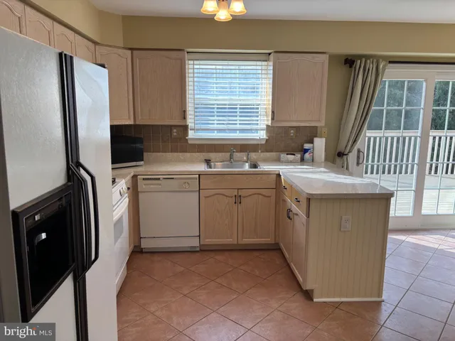 a kitchen with a sink stove and refrigerator