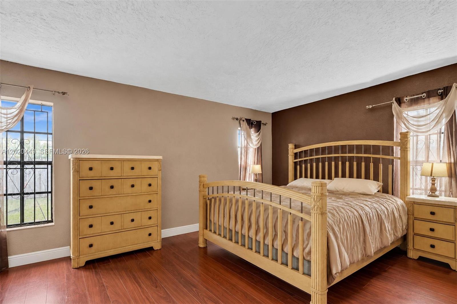 11061 Southwest 163rd Street Miami, FL 33157 - Photo 22 of 42 a bedroom with a bed and wooden floor