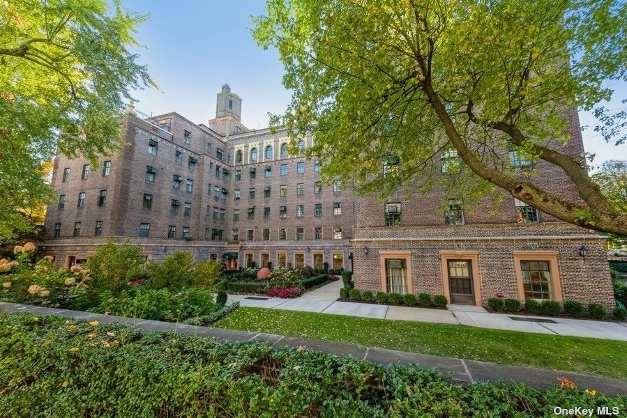 a front view of a house with a garden and plants