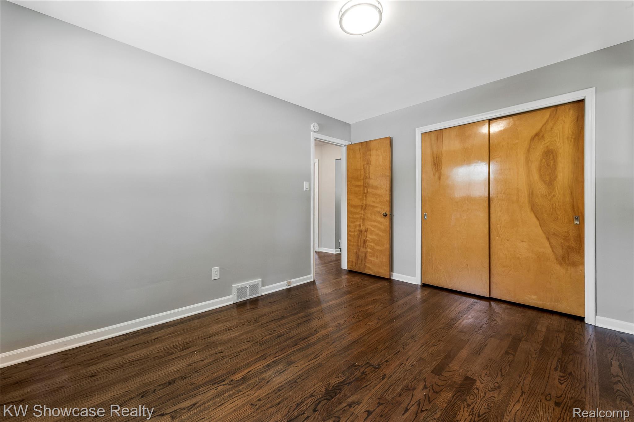 8936 Merriman Road Livonia, MI 48150 - Photo 31 of 49 Room featuring dark wood-finish flooring, light grey walls, and white baseboards