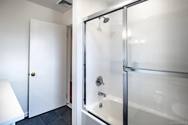 a bathroom with a bathtub and a shower
