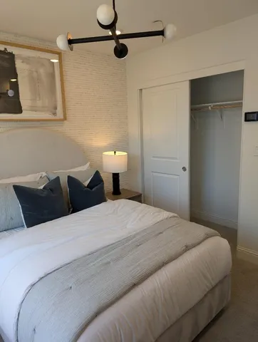 a bedroom with a bed and walk in closet