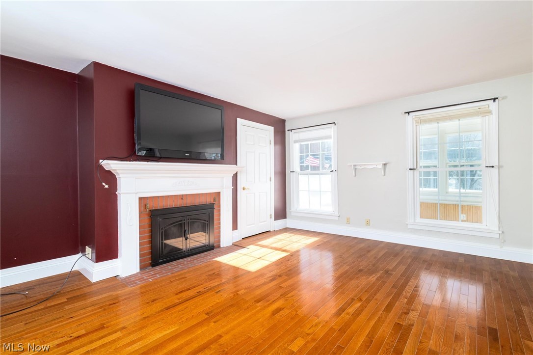 165 9th Street Wellsburg, WV 26070 - Photo 15 of 37 Unfurnished living room featuring wood-type flooring and a brick fireplace