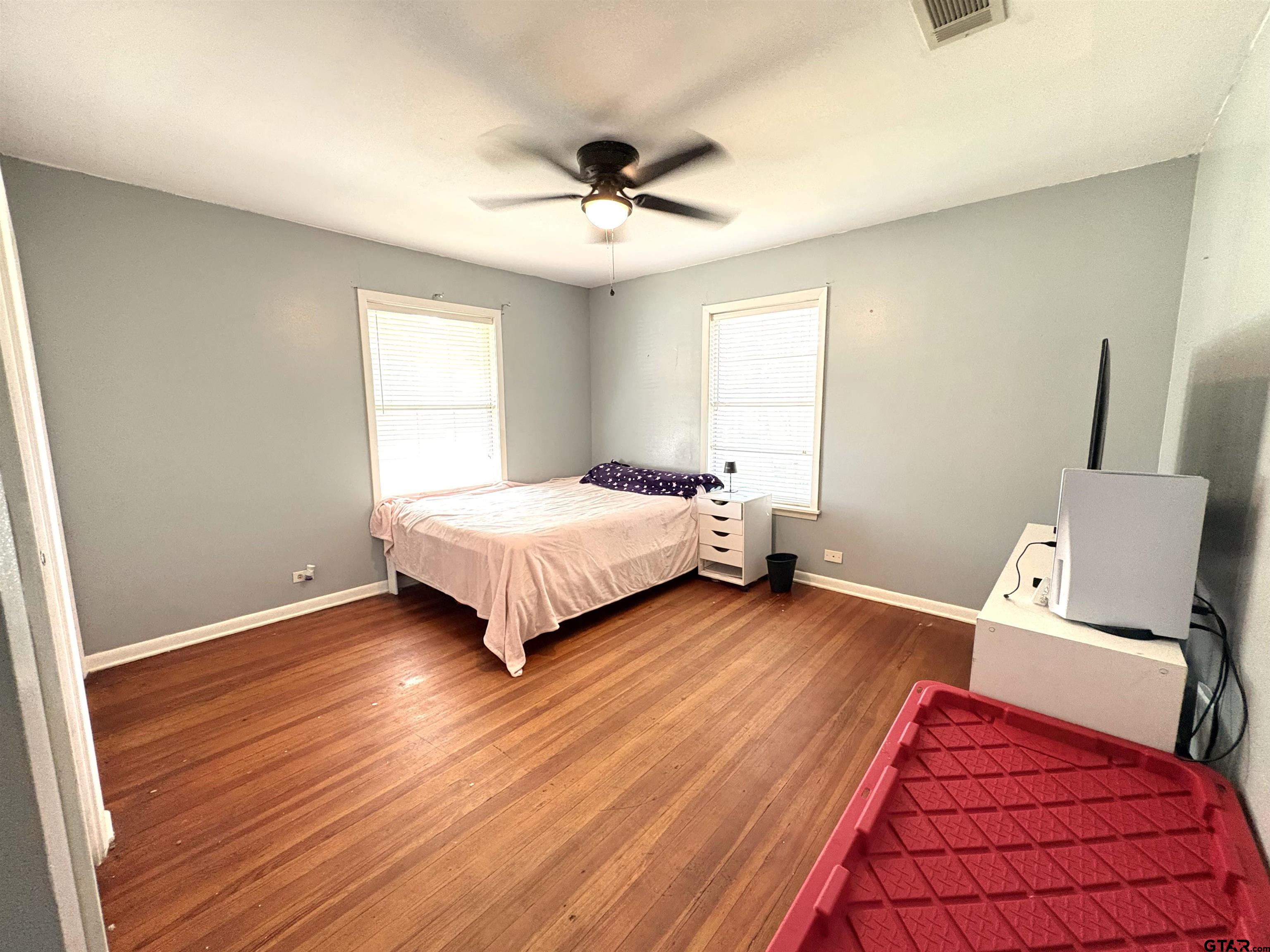 409 East Main Street Omaha, TX 75571 - Photo 11 of 15 a bedroom with a bed and wooden floor