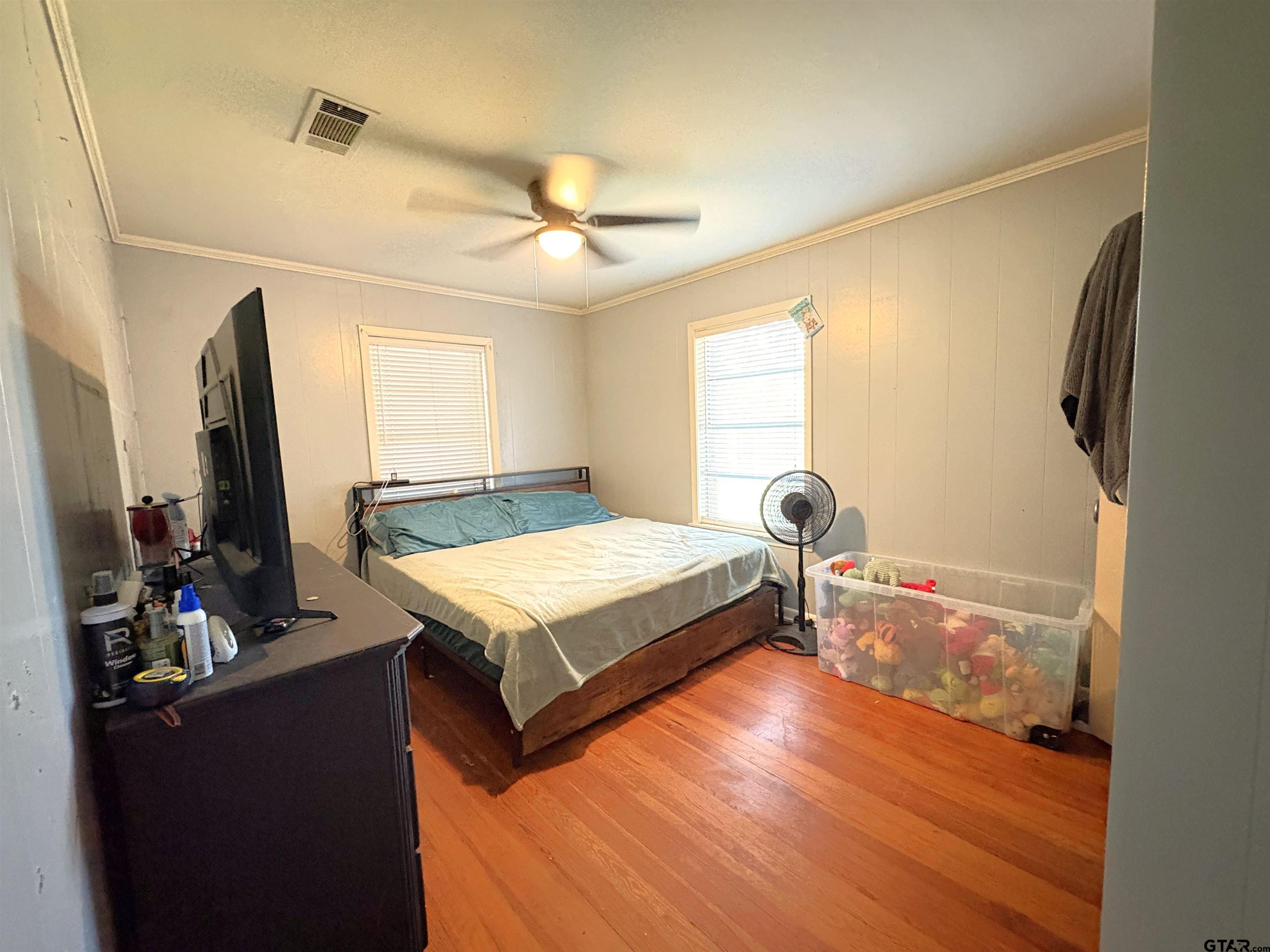 409 East Main Street Omaha, TX 75571 - Photo 13 of 15 a bedroom with a bed and a flat tv screen on the dresser