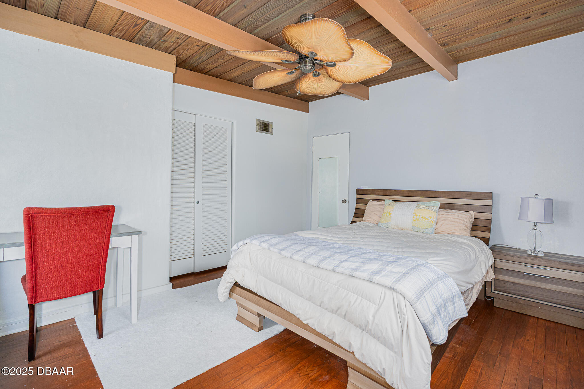 46 Oceanview Avenue Ponce Inlet, FL 32127 - Photo 20 of 79 a bedroom with a bed and a dresser with wooden floor