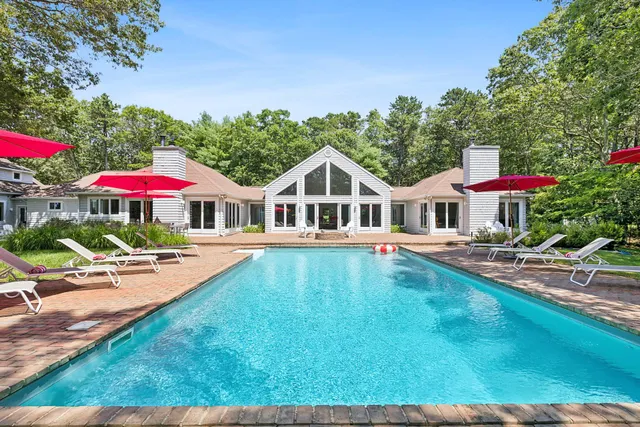 a view of a house with swimming pool and sitting area