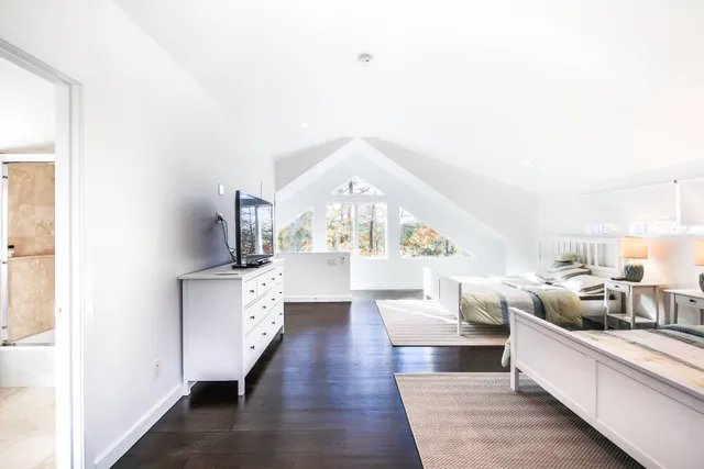 a living room with kitchen island furniture and a chandelier