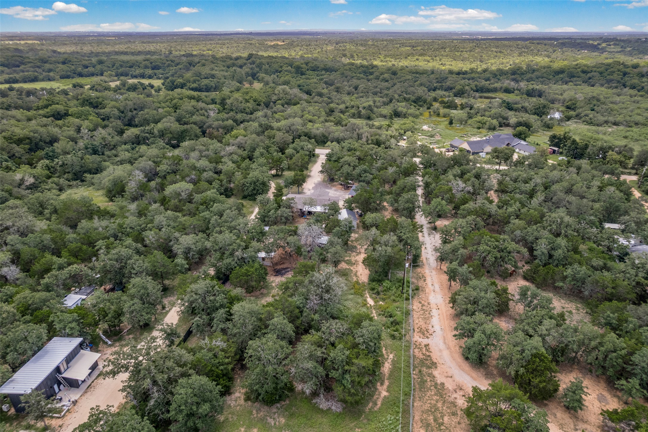 564 Boyd Road Red Rock, TX 78662 - Photo 1 of 25 Vast, verdant landscape offering multiple residences and ample space for private living.