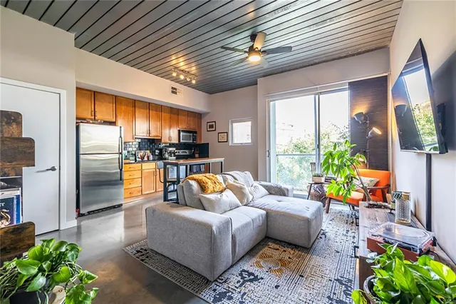 a living room with patio furniture and a fireplace
