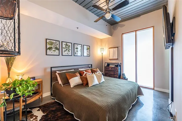 a bedroom with furniture and a potted plant