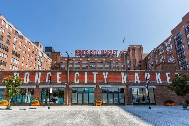 a city street lined with tall buildings and a street