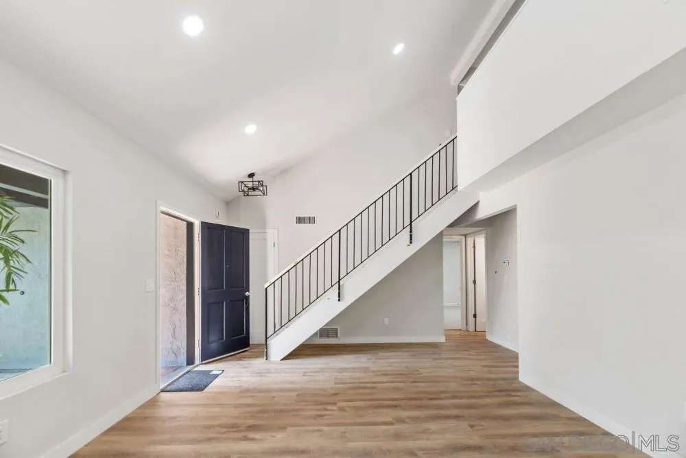 13765 Celestial Road Poway, CA 92064 - Photo 12 of 59 a view of staircase with lots of frames and white walls