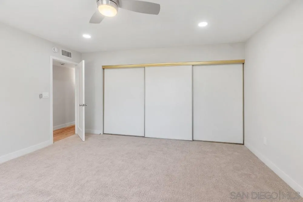 13765 Celestial Road Poway, CA 92064 - Photo 23 of 59 an empty room with a ceiling fan and closet area
