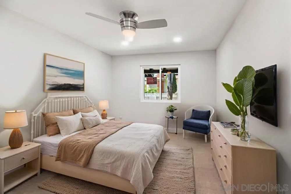 13765 Celestial Road Poway, CA 92064 - Photo 26 of 59 a bedroom with a bed a couch and a flat screen tv