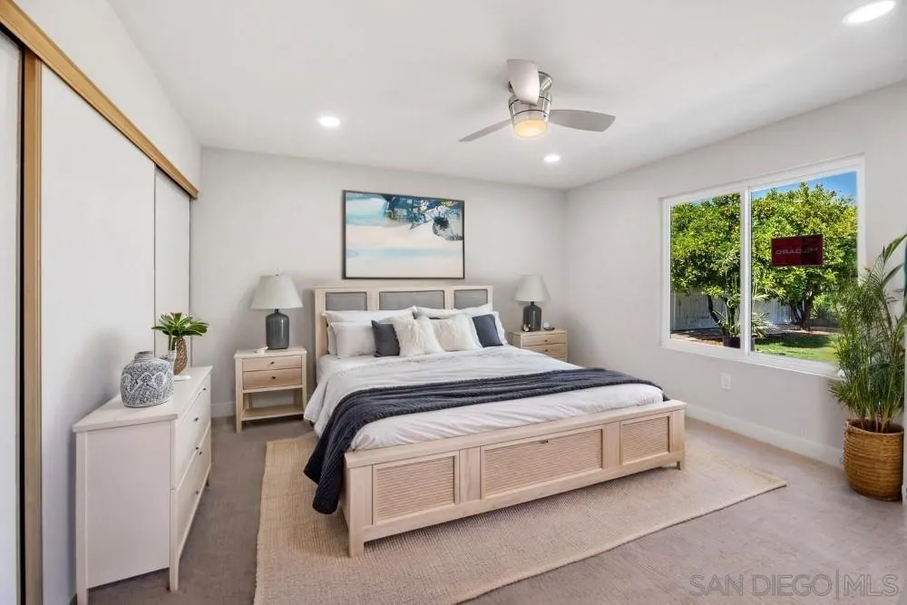 13765 Celestial Road Poway, CA 92064 - Photo 30 of 59 a spacious bedroom with a bed and a chandelier
