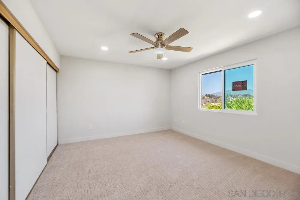 13765 Celestial Road Poway, CA 92064 - Photo 31 of 59 an empty room with window and ceiling fan