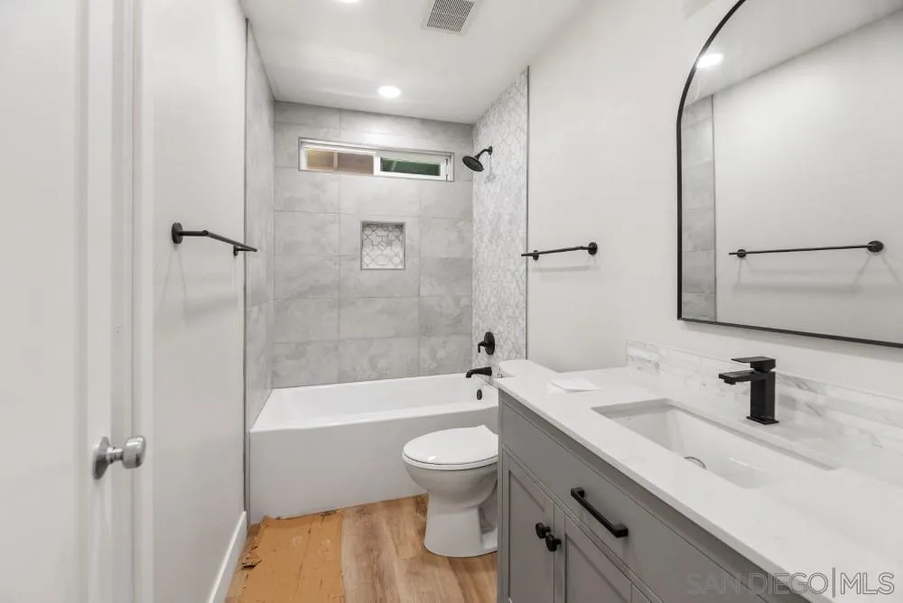 13765 Celestial Road Poway, CA 92064 - Photo 33 of 59 a bathroom with a sink a toilet and shower