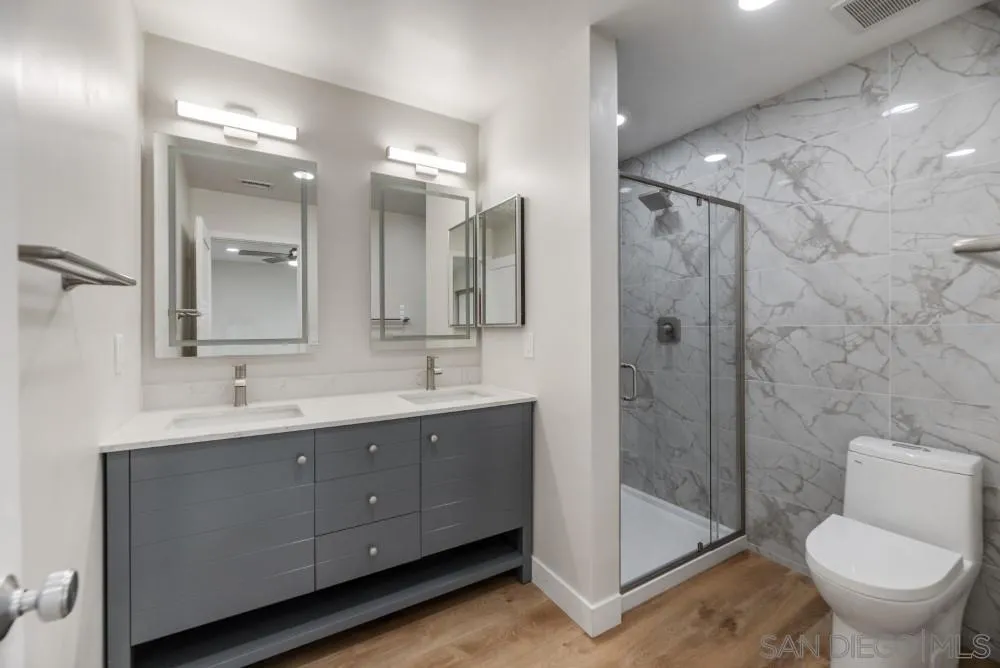 13765 Celestial Road Poway, CA 92064 - Photo 39 of 59 a bathroom with a double vanity sink toilet and shower