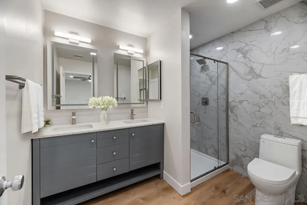 13765 Celestial Road Poway, CA 92064 - Photo 40 of 59 a bathroom with a double vanity sink toilet and shower