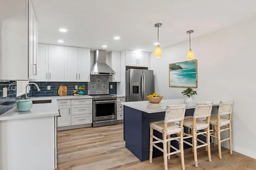 13765 Celestial Road Poway, CA 92064 - Photo 4 of 59 a kitchen with stainless steel appliances kitchen island granite countertop a table chairs and a refrigerator