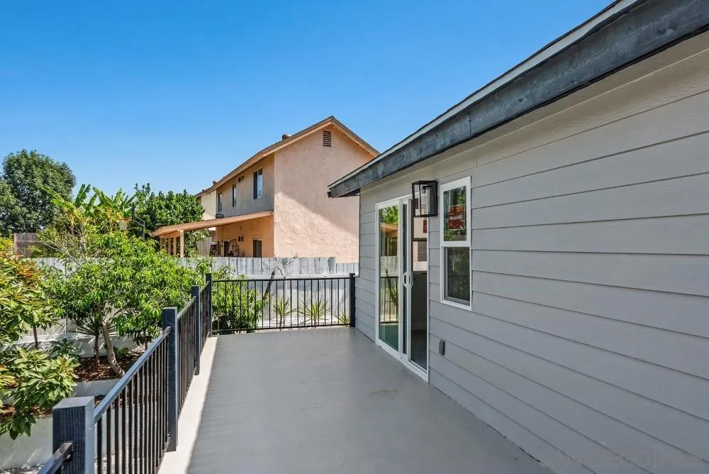 13765 Celestial Road Poway, CA 92064 - Photo 57 of 59 a view of a house with a small yard and wooden floor and fence
