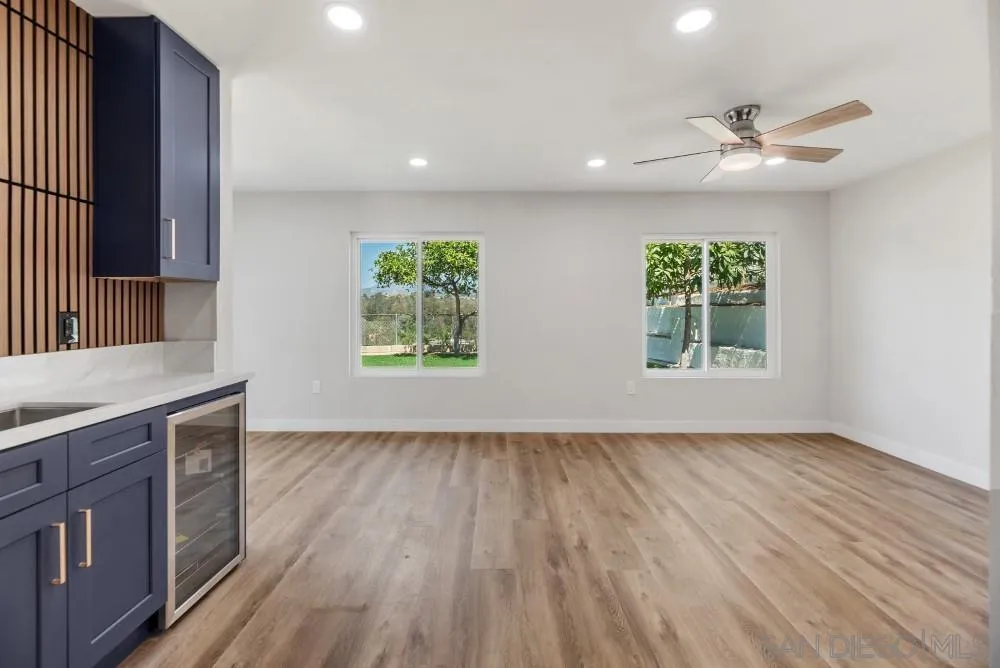 13765 Celestial Road Poway, CA 92064 - Photo 8 of 59 an empty room with wooden floor and windows